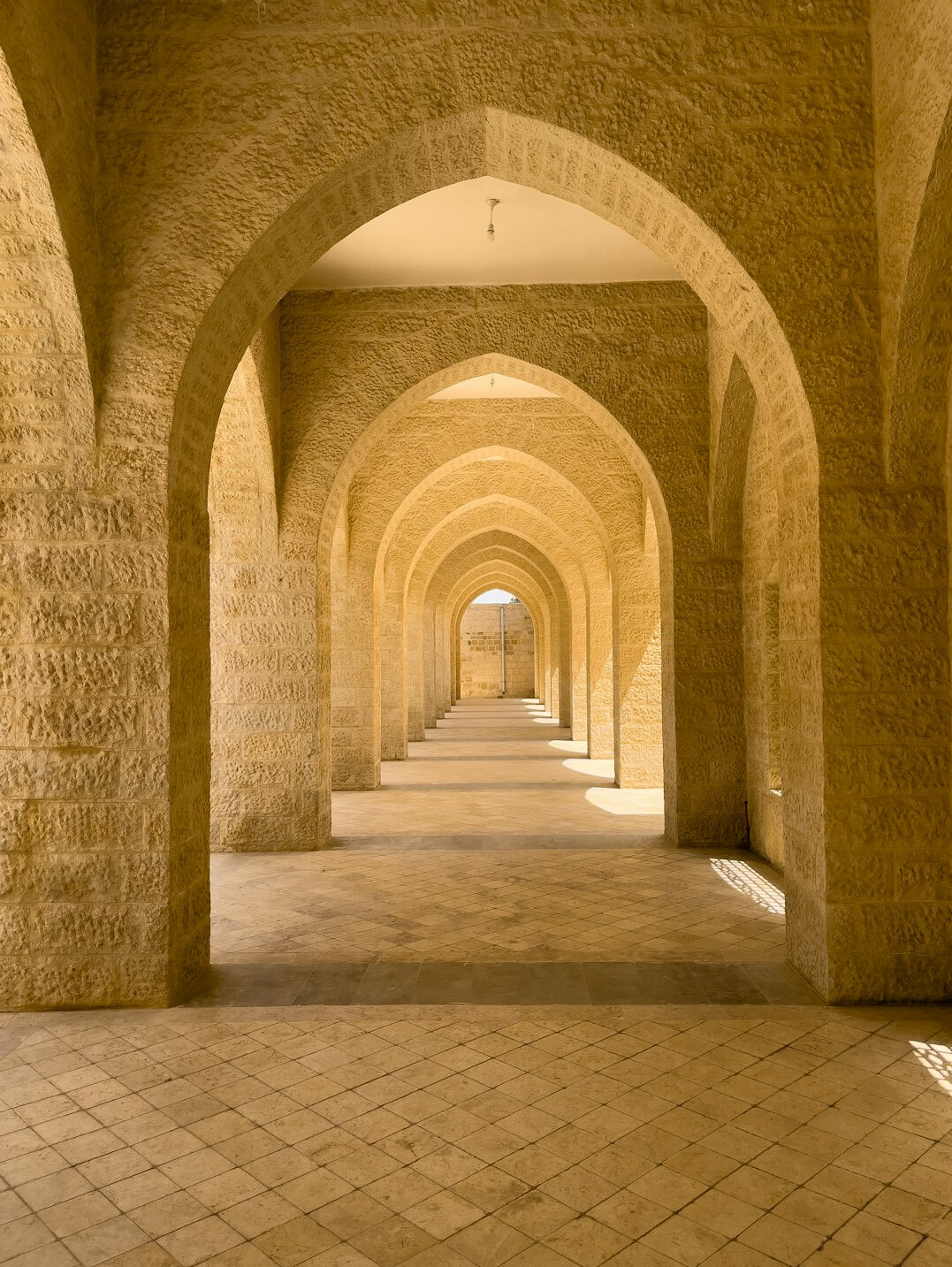 Long corridor of arches with warm light