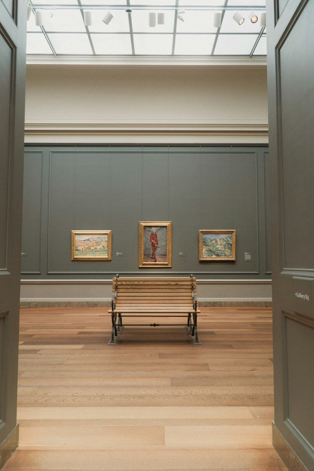 Empty gallery hall with a single wooden bench