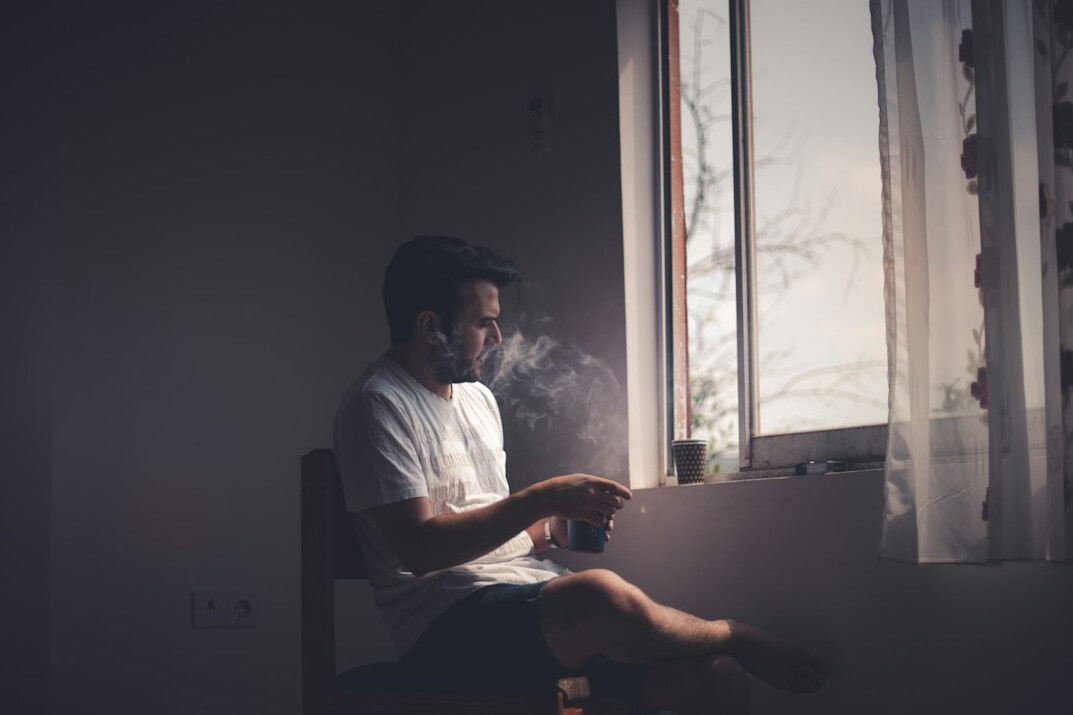 person reflecting alone with laptop