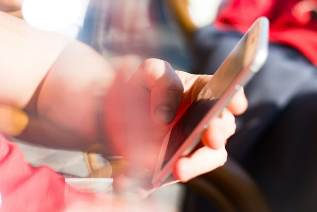 person scrolling on smartphone