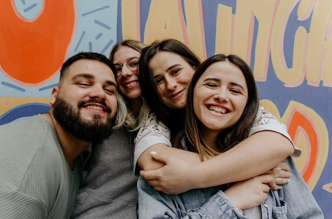 diverse group of friends embracing