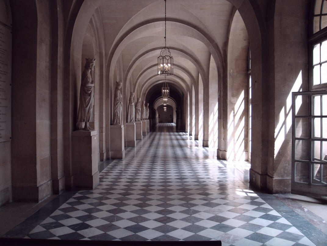 Wide hall of columns with a distant bright opening